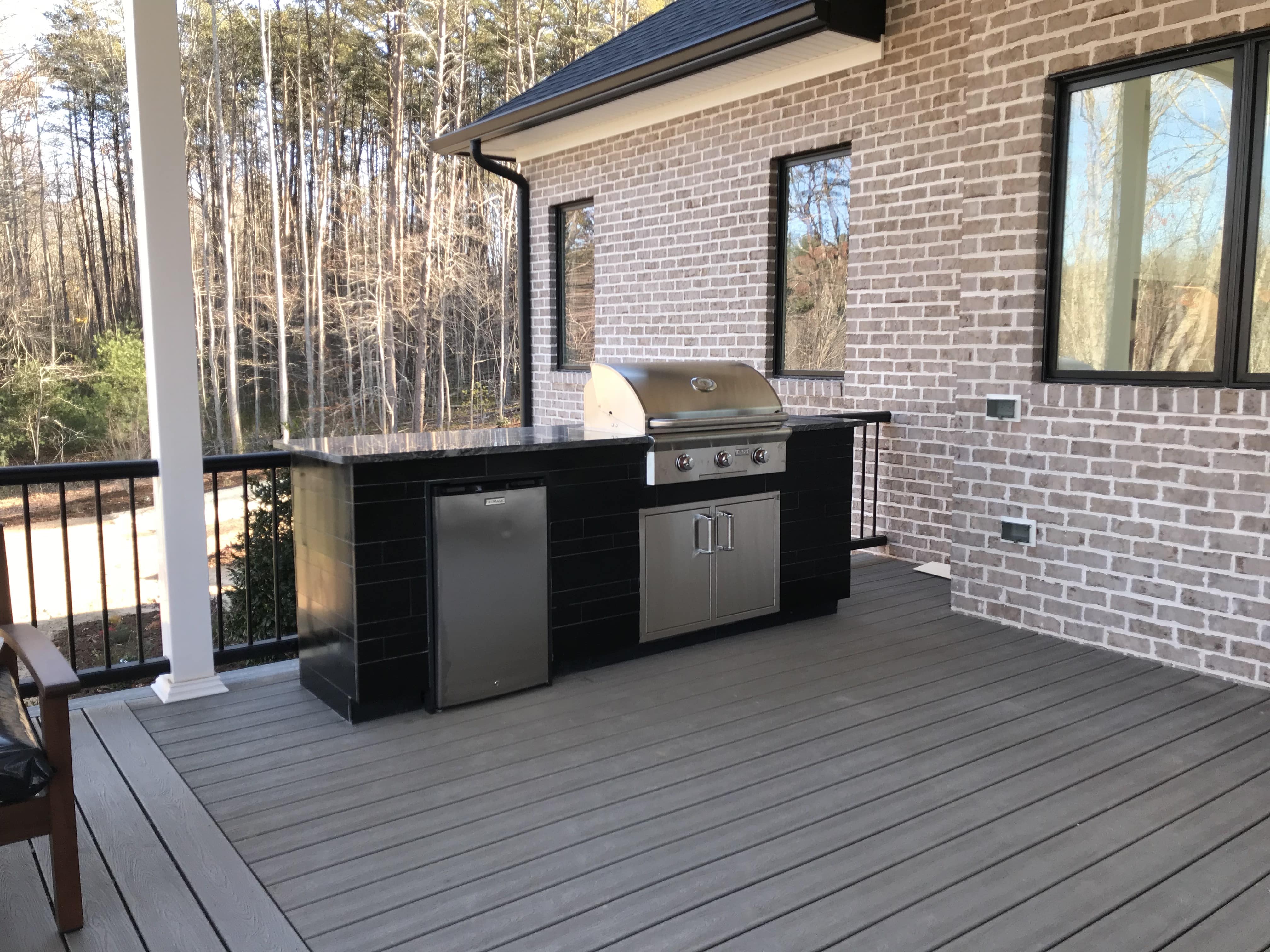 Norstone Ebony Planc Large Format Tile Being installated as the veneer on a residential outdoor kitchen project